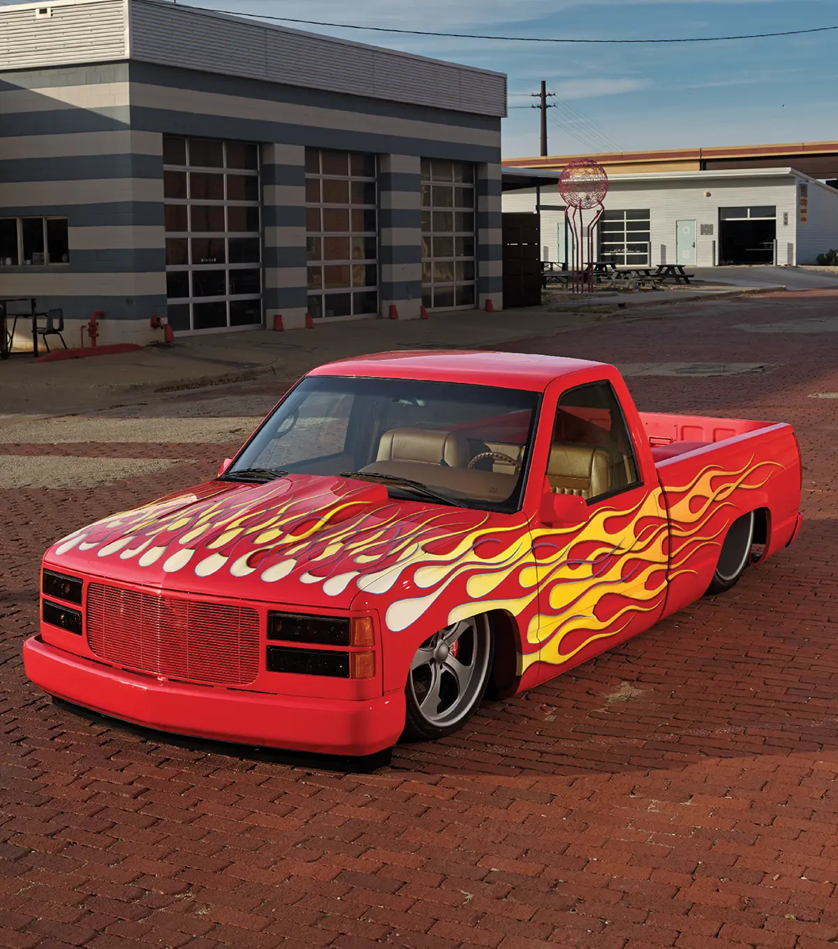 1996 Chevy C1500 with candy red paint and custom yellow-to-orange flame graphics