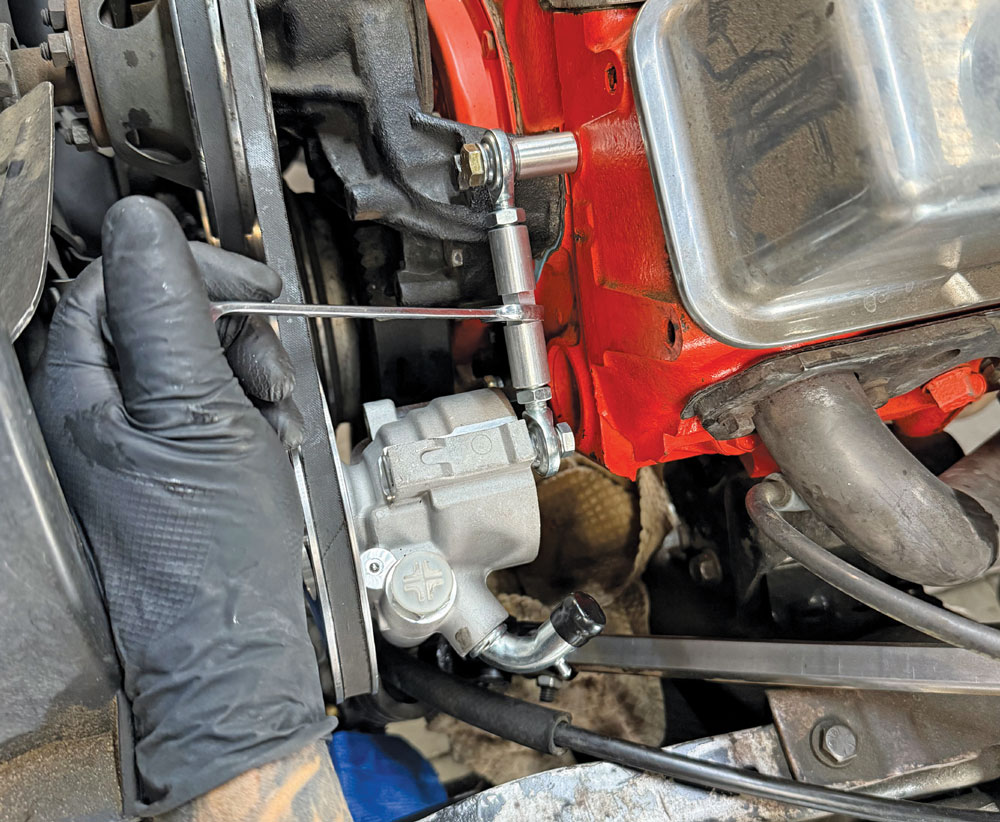 applying red threadlocker to billet pump tension rod bolts