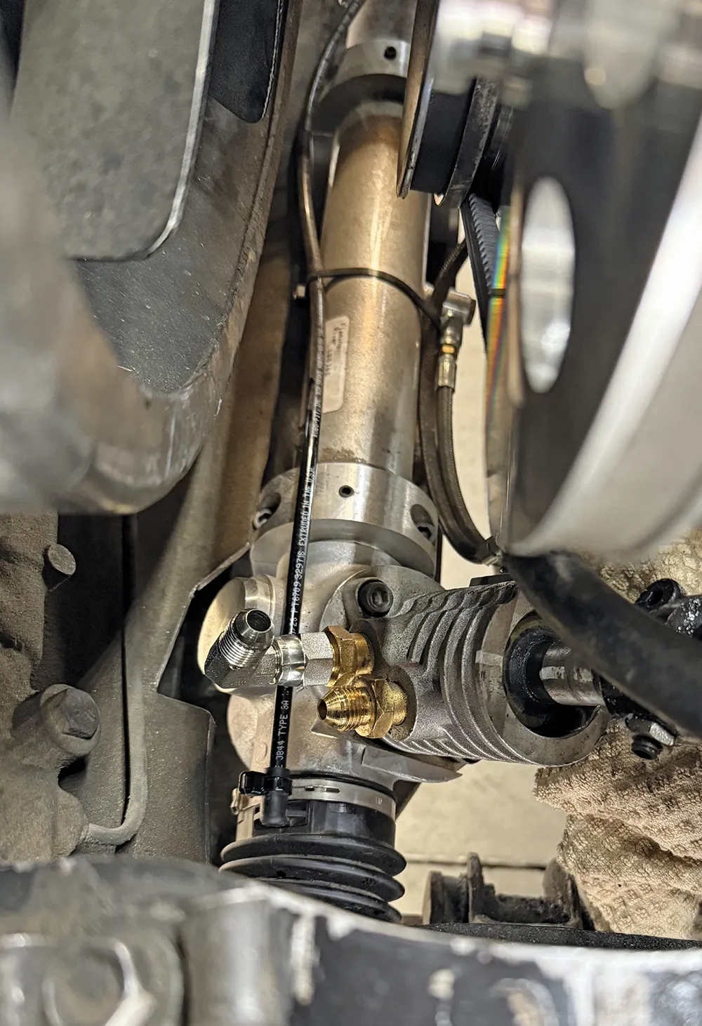 braided stainless line routing for remote power steering reservoir