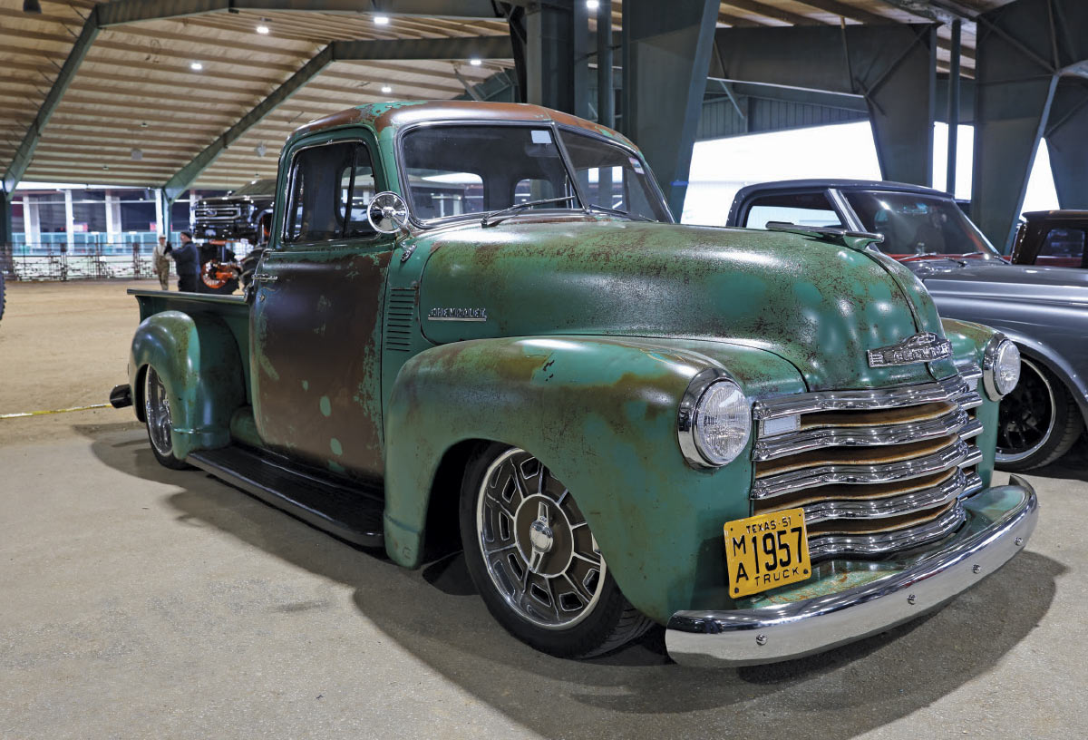 1957 Chevrolet 3100 in patina green with updated wheels and suspension, maintaining classic Advance Design style
