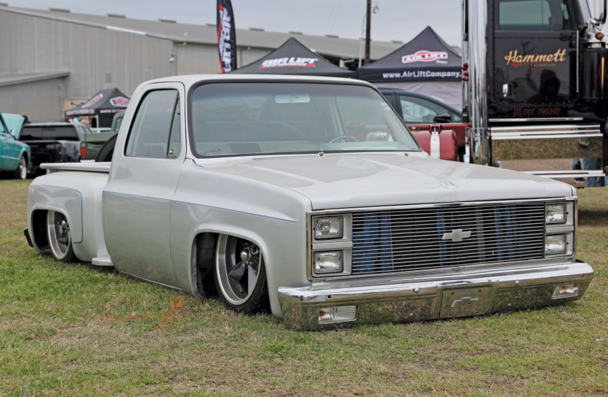 1986 Chevrolet C10 Squarebody in pearl white with billet grille, ghost flames, and staggered billets