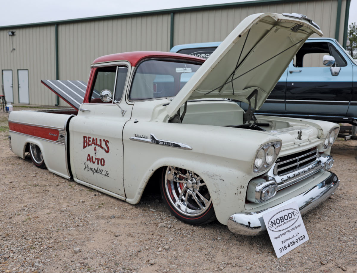 1959 Chevrolet Apache Fleetside rocking shop truck style with red accents and staggered polished wheels