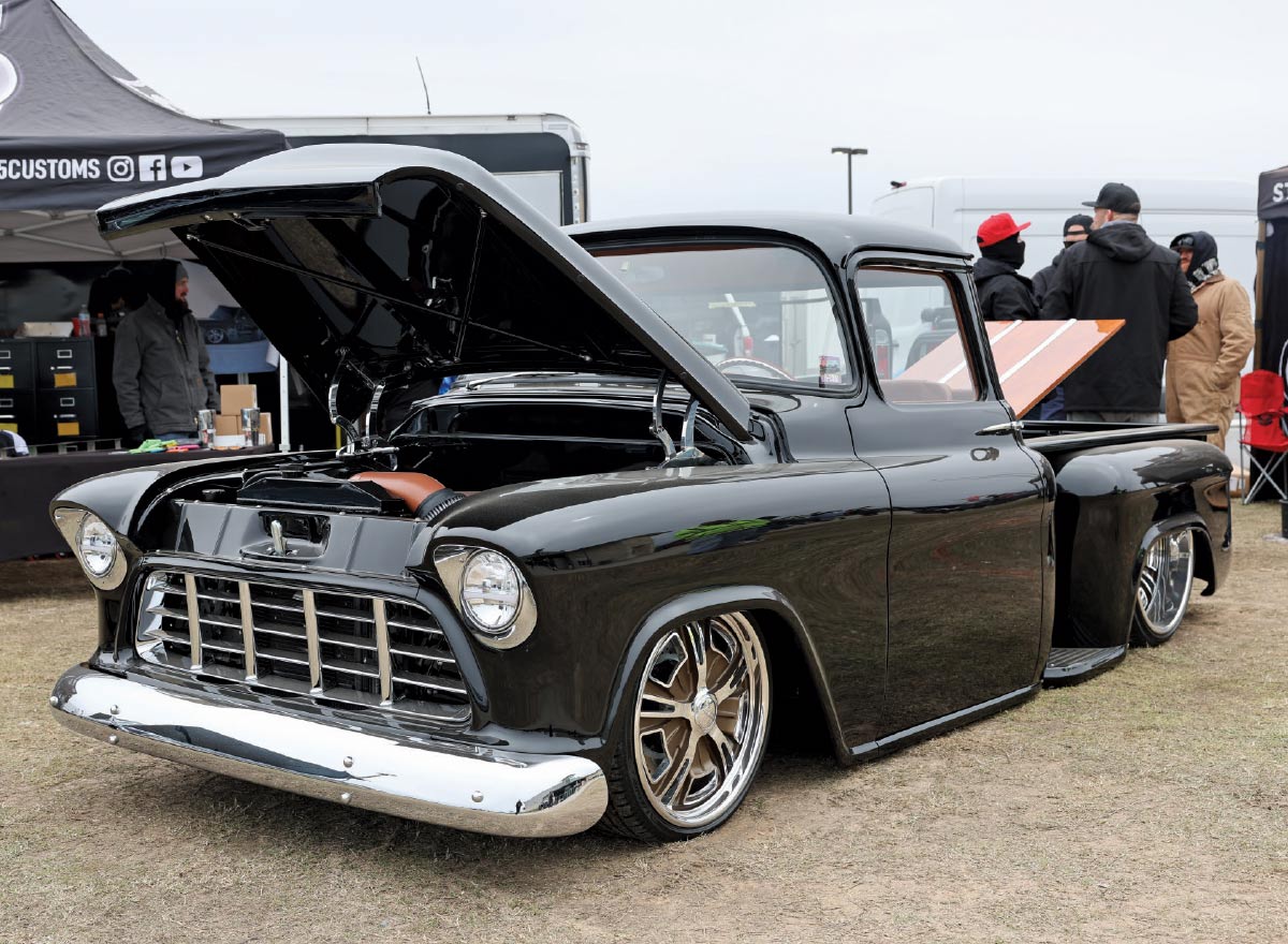 1956 Chevrolet 3100 Task Force in gloss black with chrome bumpers, tucked billet wheels, and smoothed hood