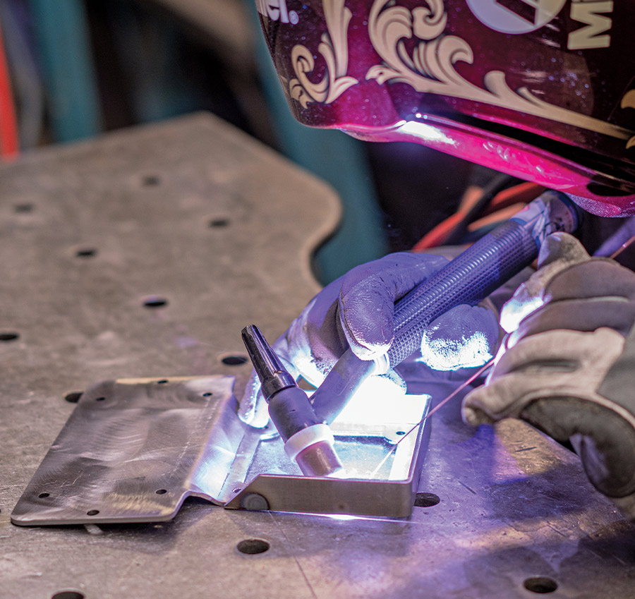 TIG welding bracket for AccuAir tank setup, precise beadwork on aluminum mount