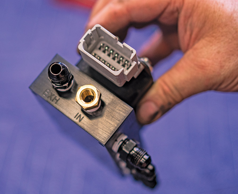 Detail of AccuAir VU4 block showing labeled ports for EXH and IN with plug connector