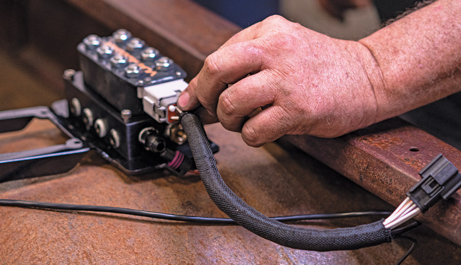 Harness being connected to AccuAir VU4 block mounted on bed crossmember of the 1959 Apache