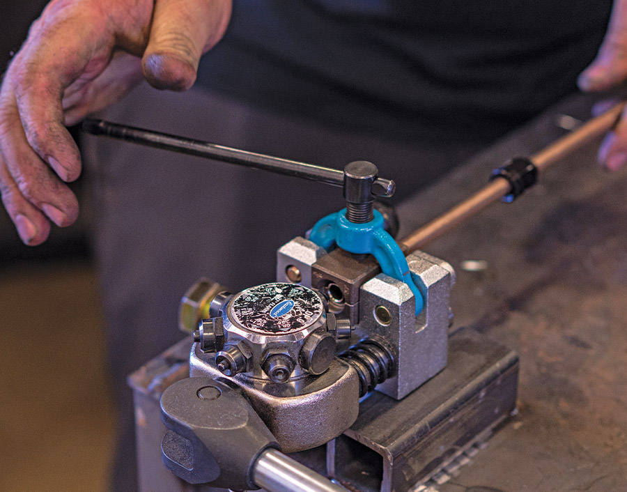 Precision tube bender forming accurate bends in copper air line for clean install layout