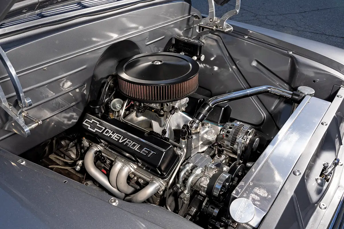 1957 Chevrolet small block crate engine with headers, serpentine setup, and billet hinges