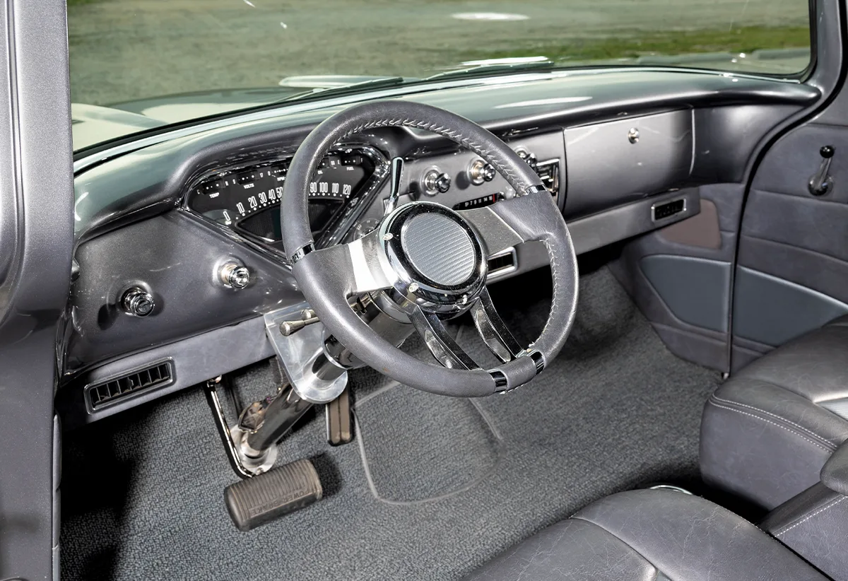 1957 Chevy truck custom dash with billet steering wheel and retro-style gauges