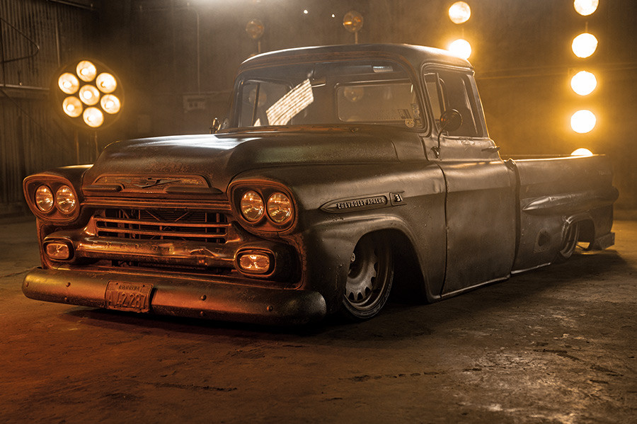 1959 Chevy Apache laid out on air suspension with moody lighting and patina finish