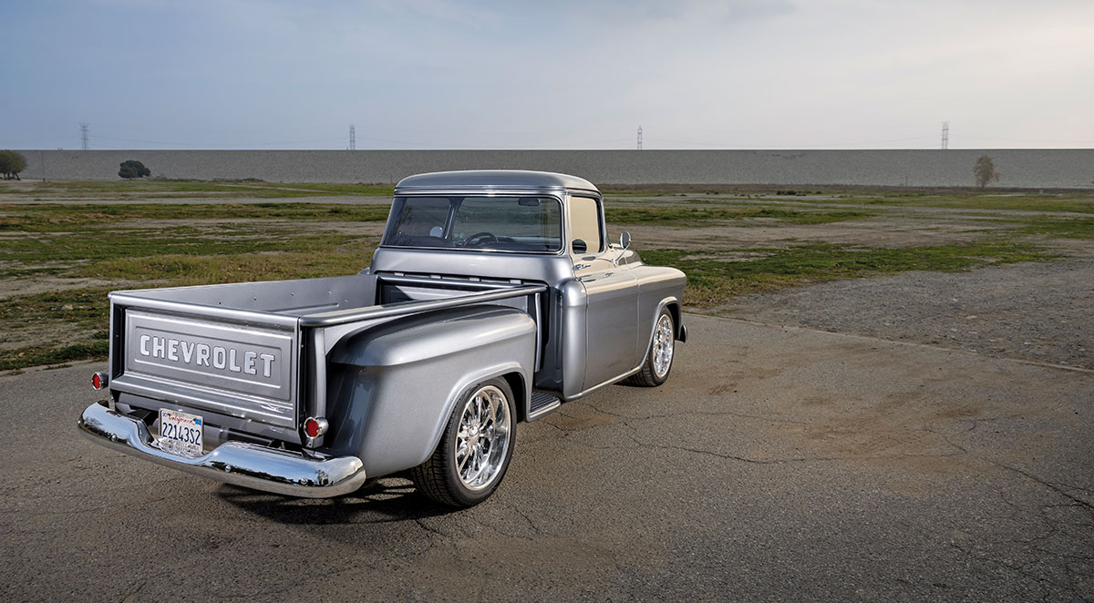 1957 Chevy 3100 step-side rear view with embossed tailgate and clean chrome bumper