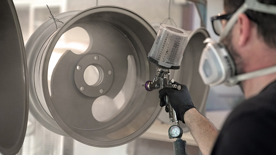 Fresh Cerakote being sprayed onto Slater wheels for a modern satin look