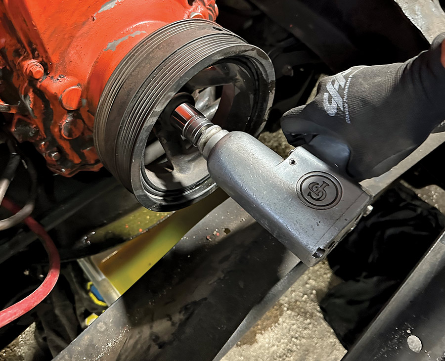 Crank pulley bolt being removed using an impact gun
