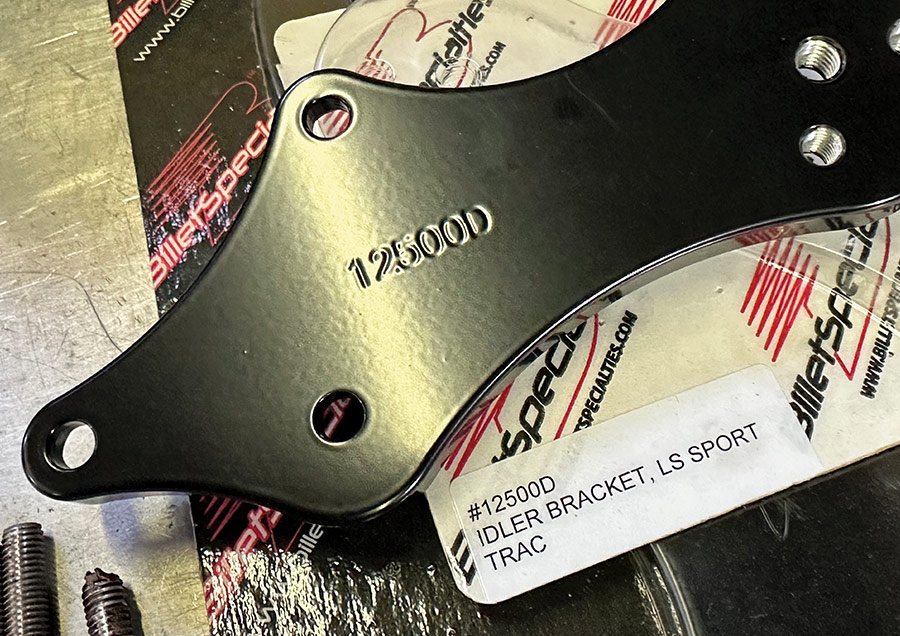 Close-up of Billet Specialties #12500D idler bracket labeled for LS Sport Trac