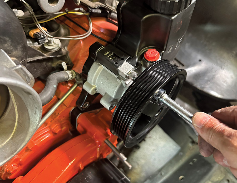 Power steering pulley being bolted onto pump already mounted to bracket