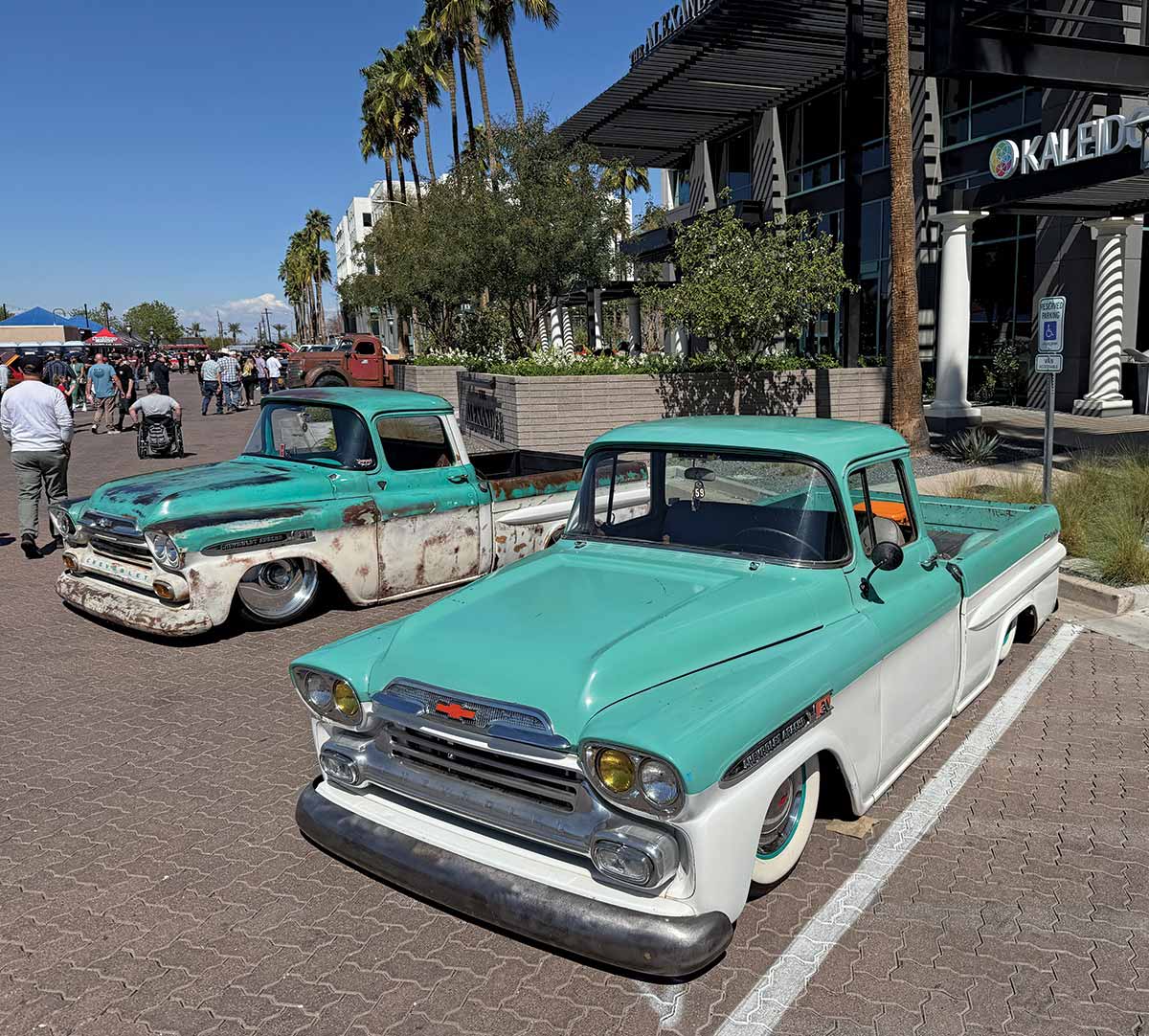 Pair of 1958 Chevy Apache Fleetside trucks, both bagged, with one in patina and the other in clean turquoisewhite
