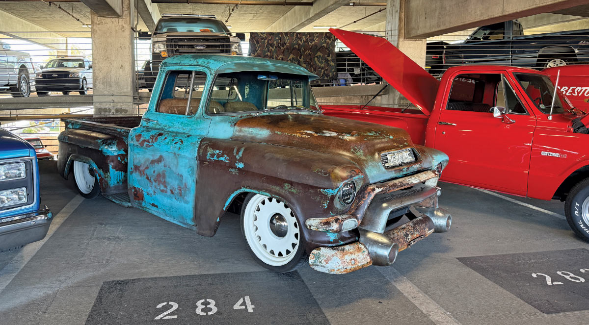 1957 GMC pickup with raw patina and white Detroit Steel wheels sitting slammed on air suspension