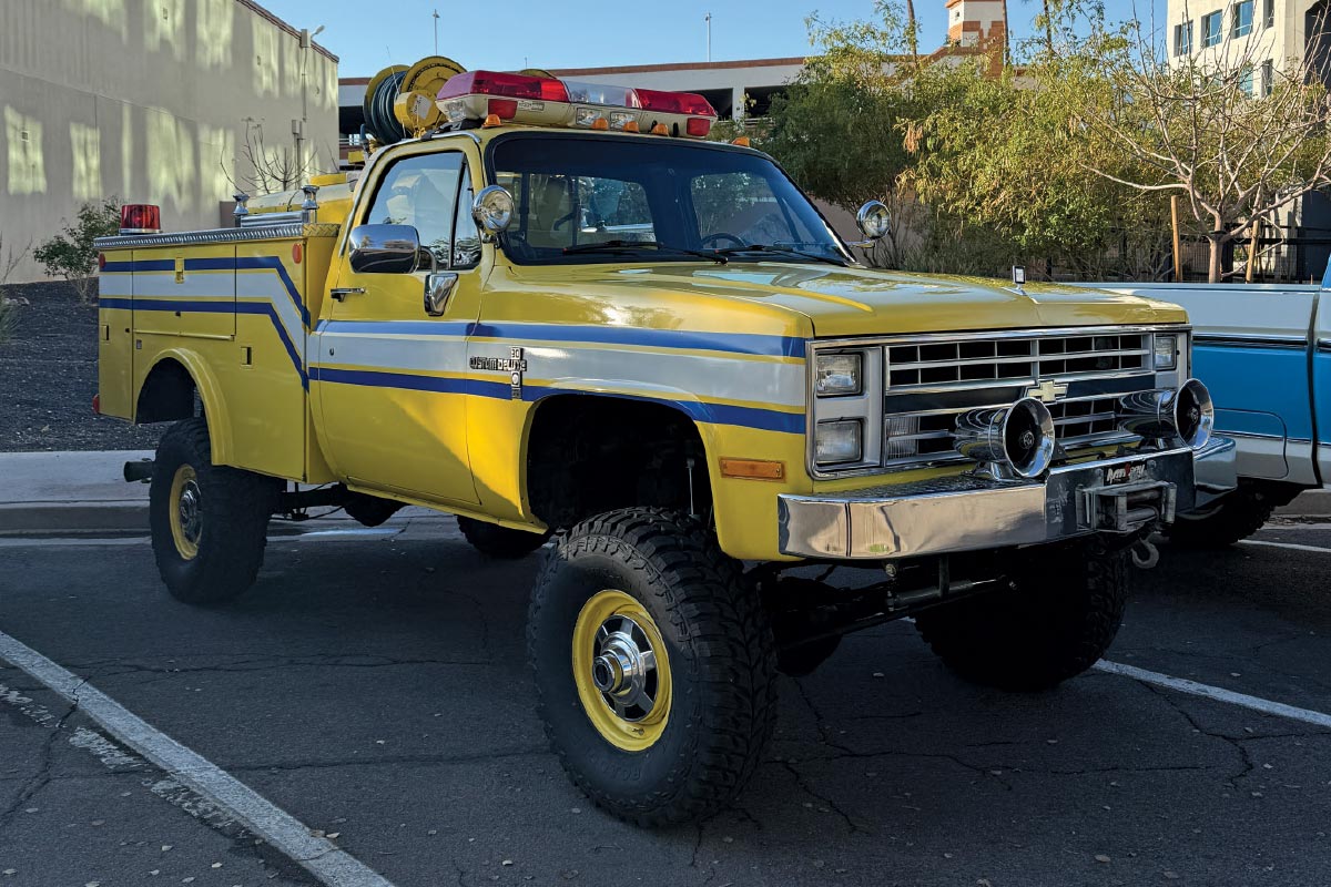 1986 Chevrolet K30 fire rescue truck in yellow with utility body, lift, and vintage lightbar setup