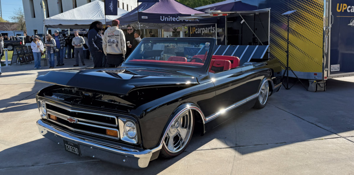 1970 Chevrolet C10 convertible in gloss black with red interior and large billet wheels