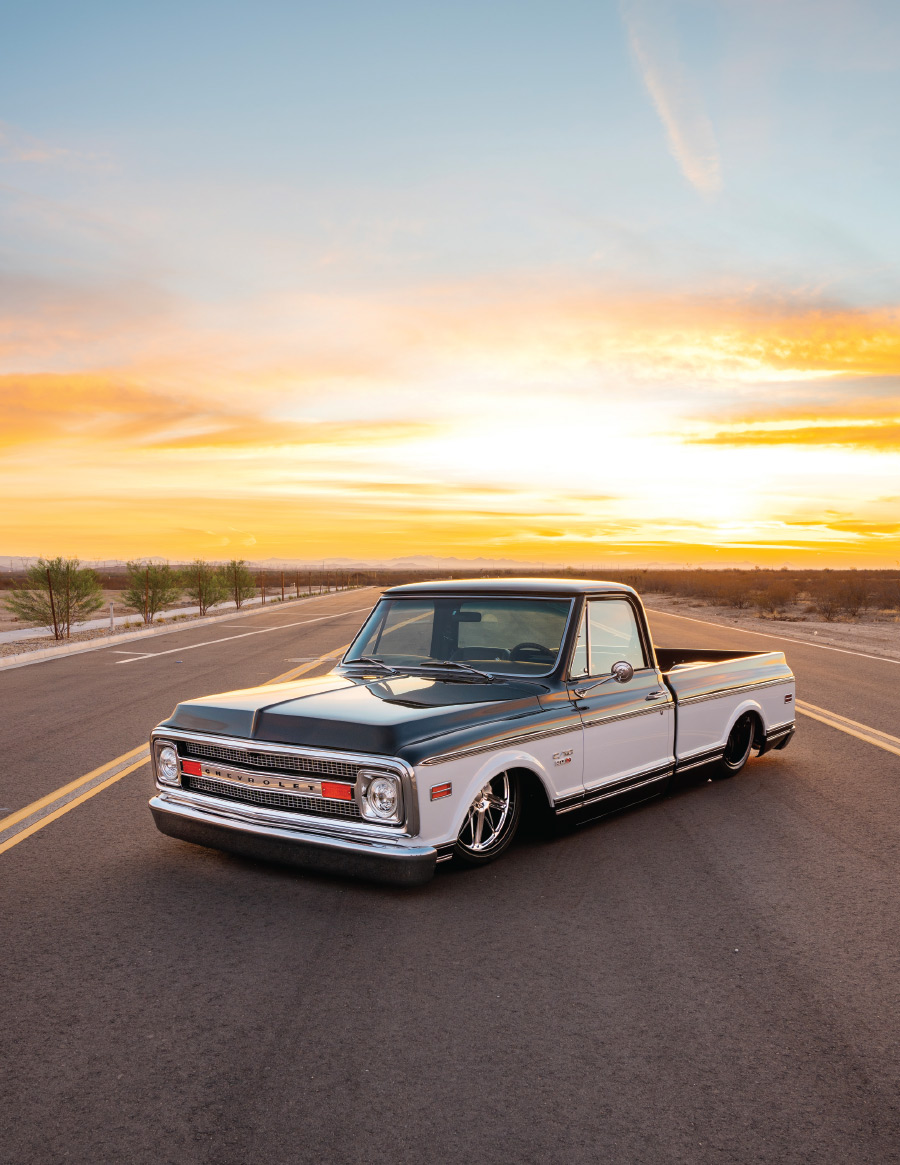 Hicks 1969 C10 parked on a desert road with sun setting behind it