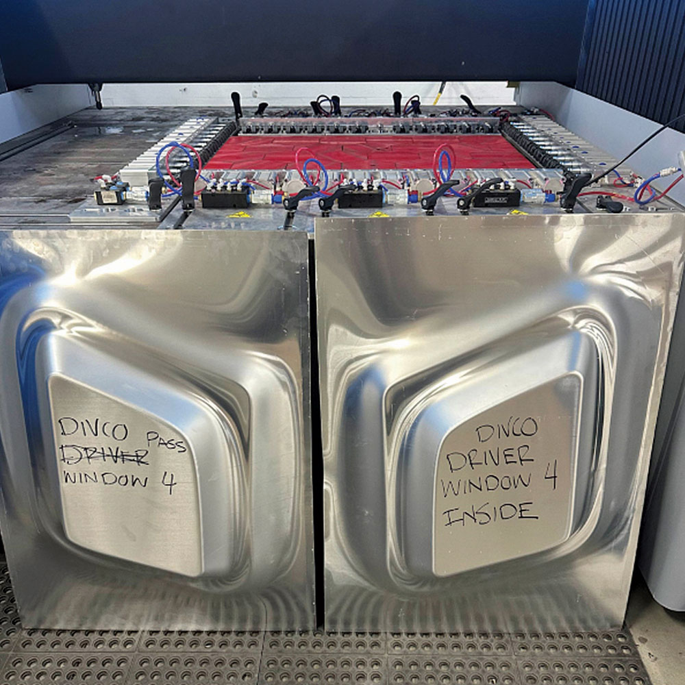Divco hydroformed window panels labeled for driver and passenger side use with sharp tooling detail