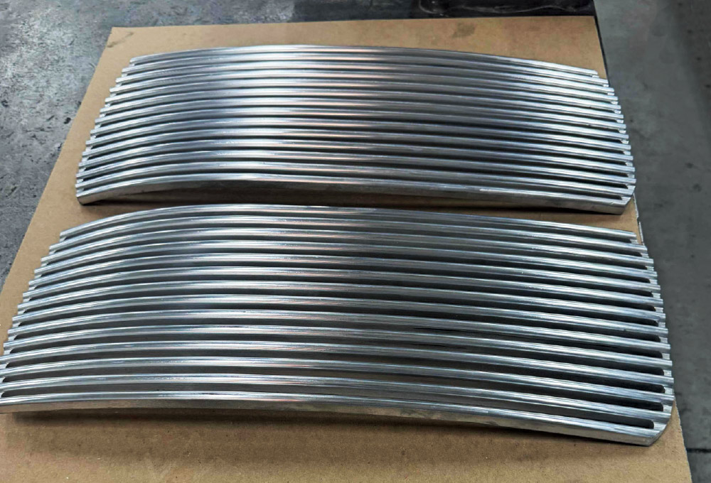 Divco custom grille bars CNC-machined in curved profile with consistent spacing and taper