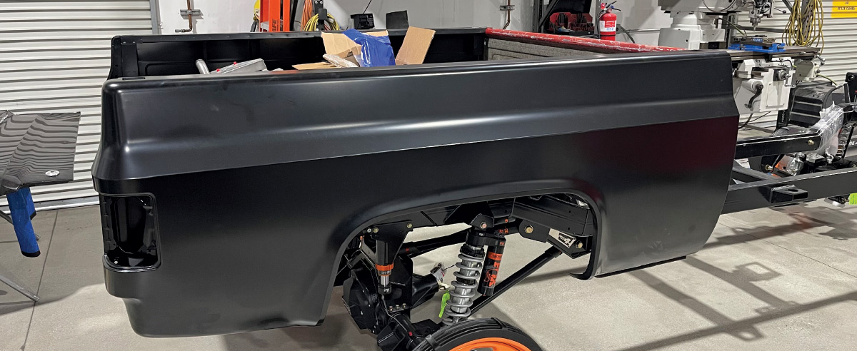 1985 chevy squarebody front suspension close-up with goodyear wrangler tire and raceline forged wheel