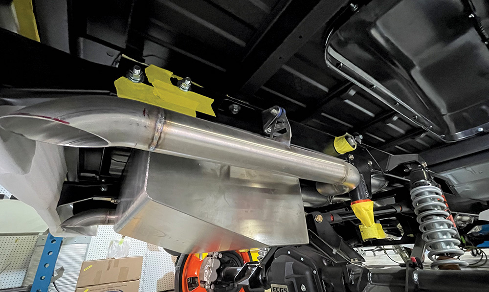 1985 chevy squarebody rear coilover and exhaust mockup under bed with raw tubing and mounts
