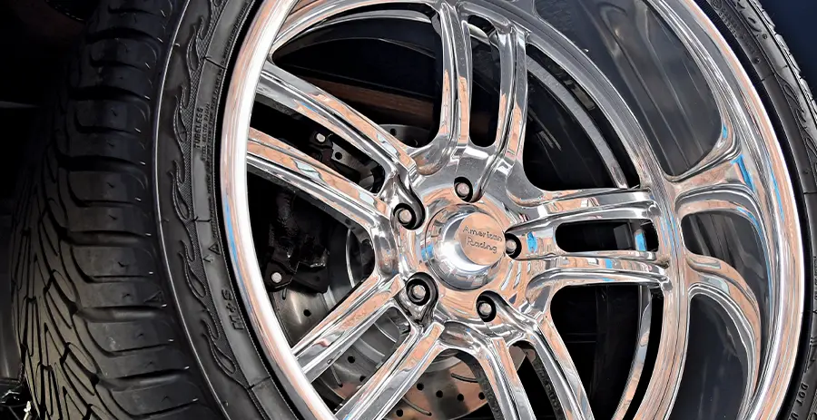 1955 Ford F-100 rear wheel close-up American Racing polished wheels performance tires