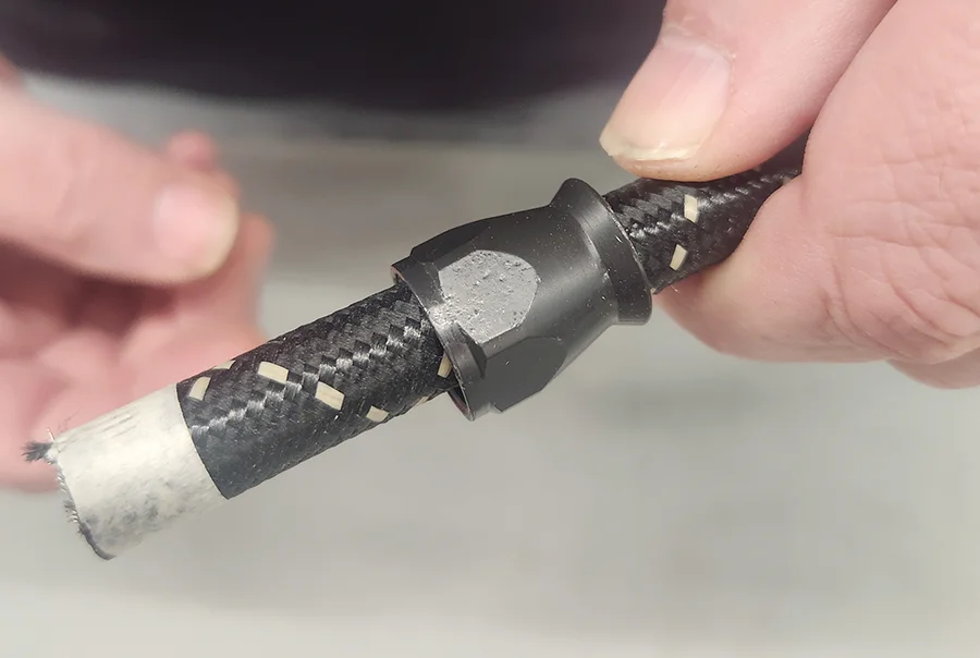 Braided hose sleeve mockup with tape and AN fitting collar test fit