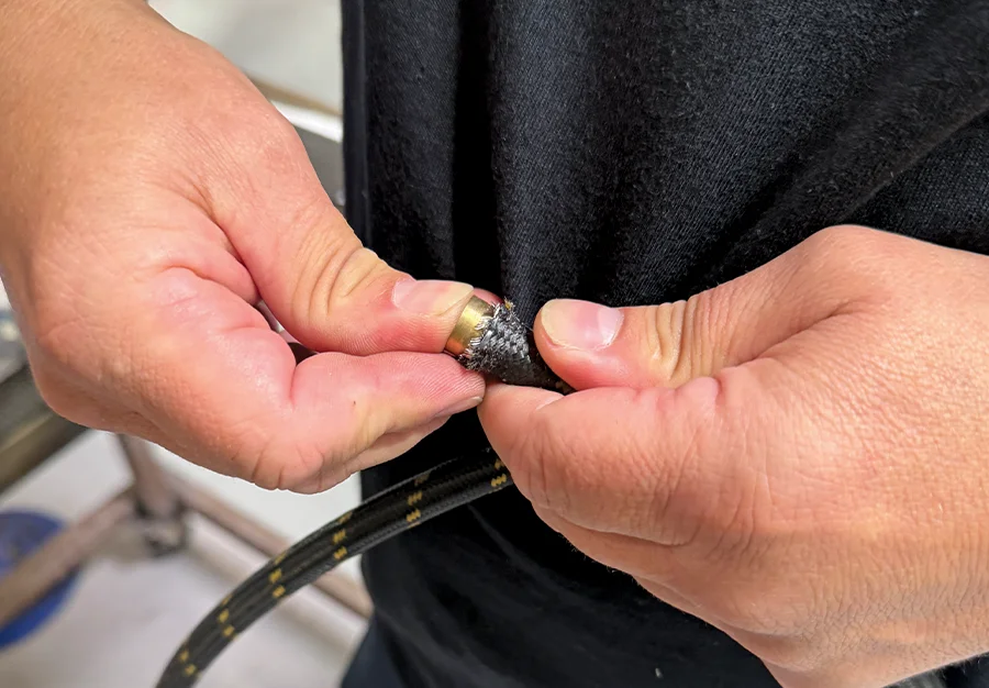Inserting brass guide into braided hose core before AN fitting install