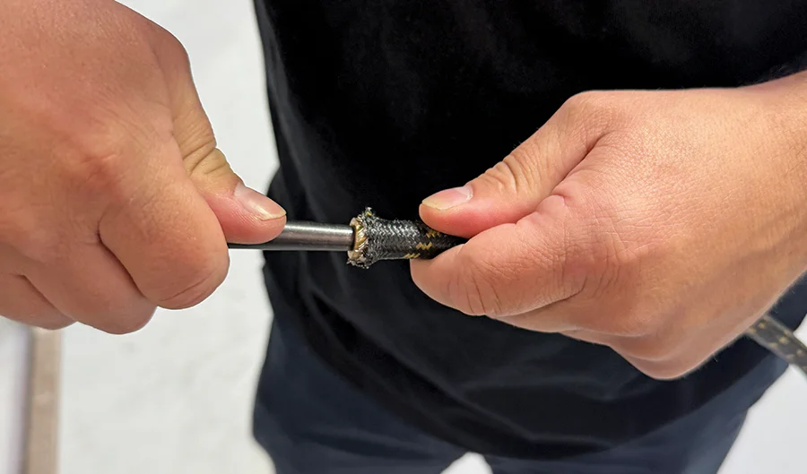 Cleaning debris and adjusting braid with pick for tight AN seal