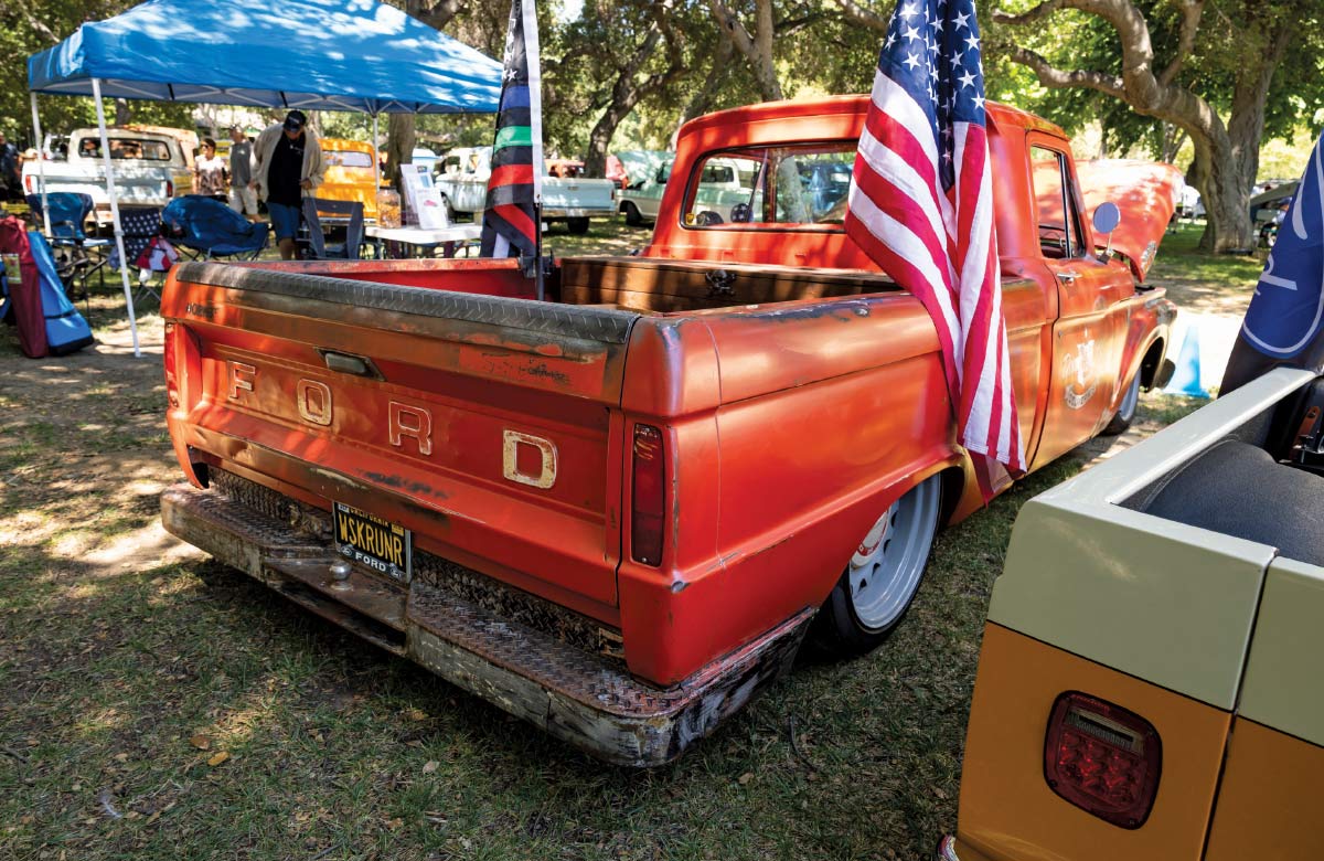 1966 Ford F-100 patina red bed USA flag lowered rear view