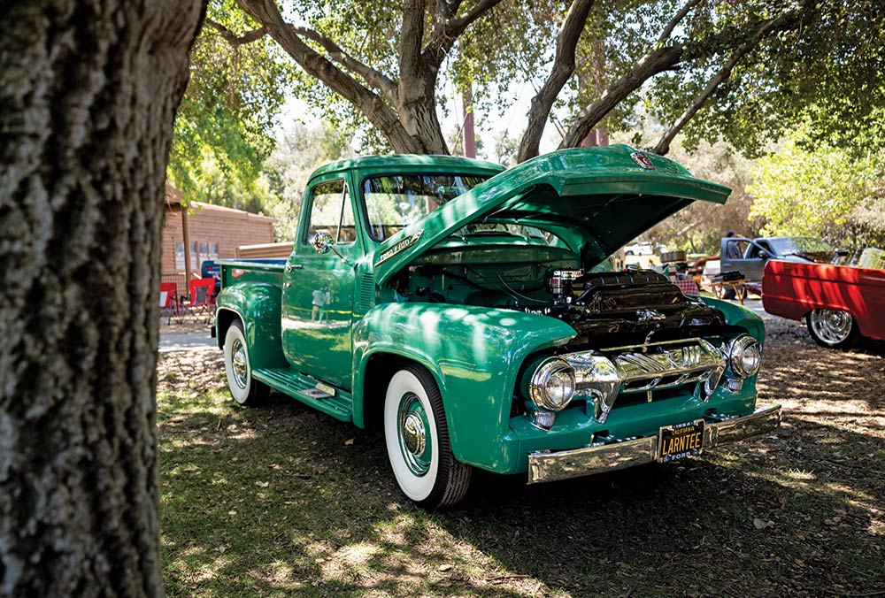 1955 Ford F-100 emerald green resto build whitewalls chrome trim under trees