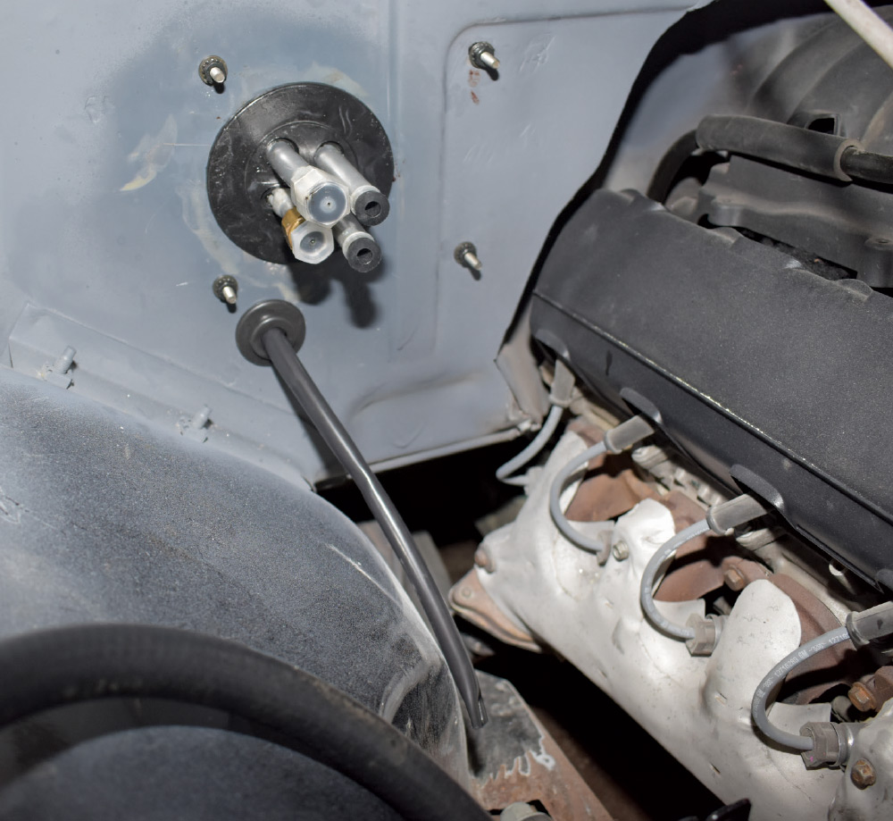 1951 Chevy AC firewall port fittings installed LS engine bay view