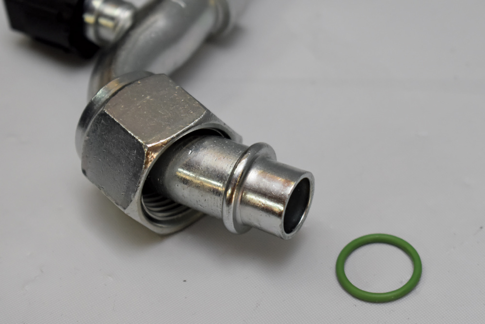 1951 Chevy AC line green O-ring seal close-up aluminum fitting refrigerant connection prep