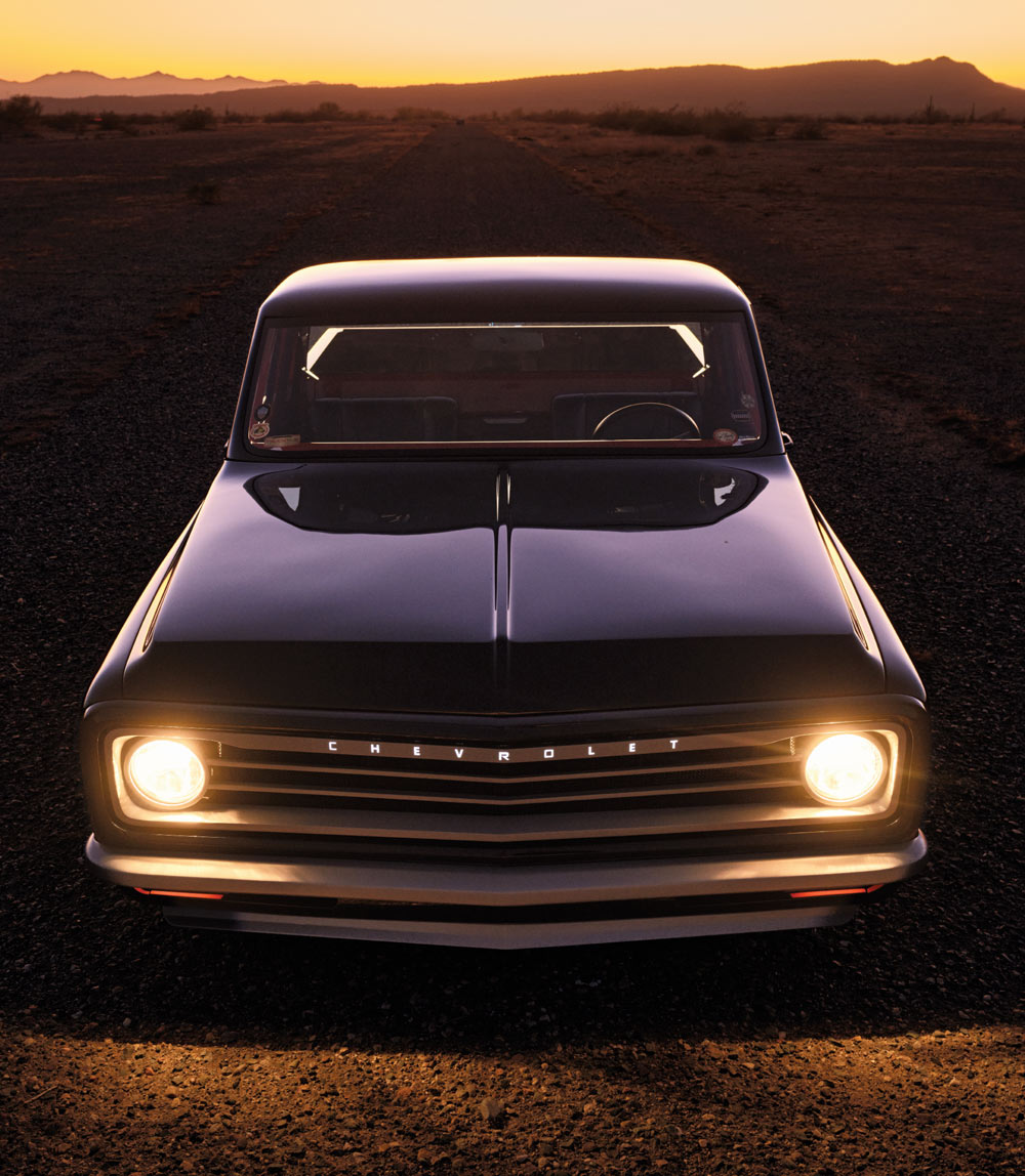 Black 1972 Chevy C10 front angle, sunset lighting, custom wheels, gravel road