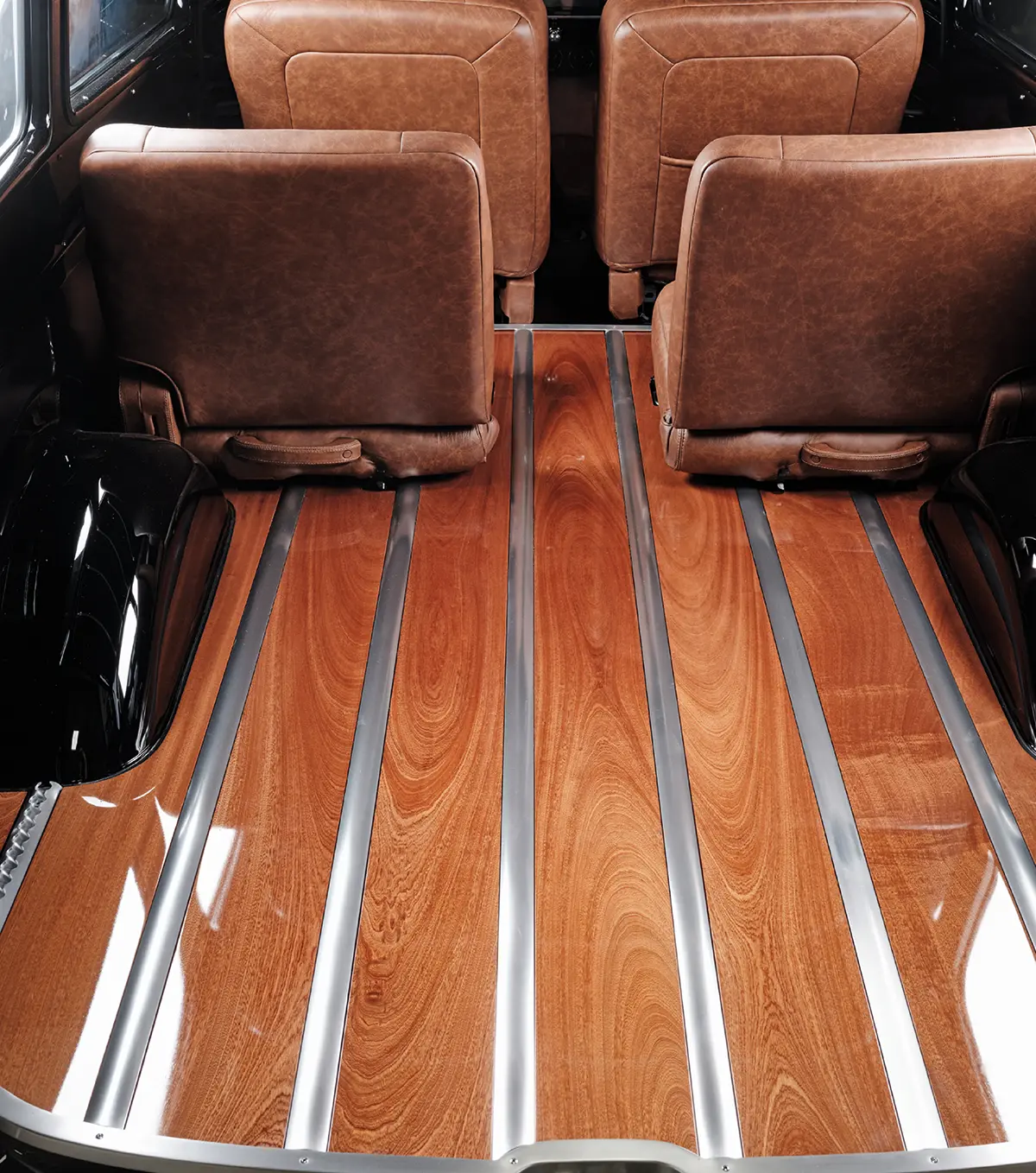 1952 Chevy Suburban cargo area, wood plank floor, polished metal strips, seatbacks, glossy black wheel well