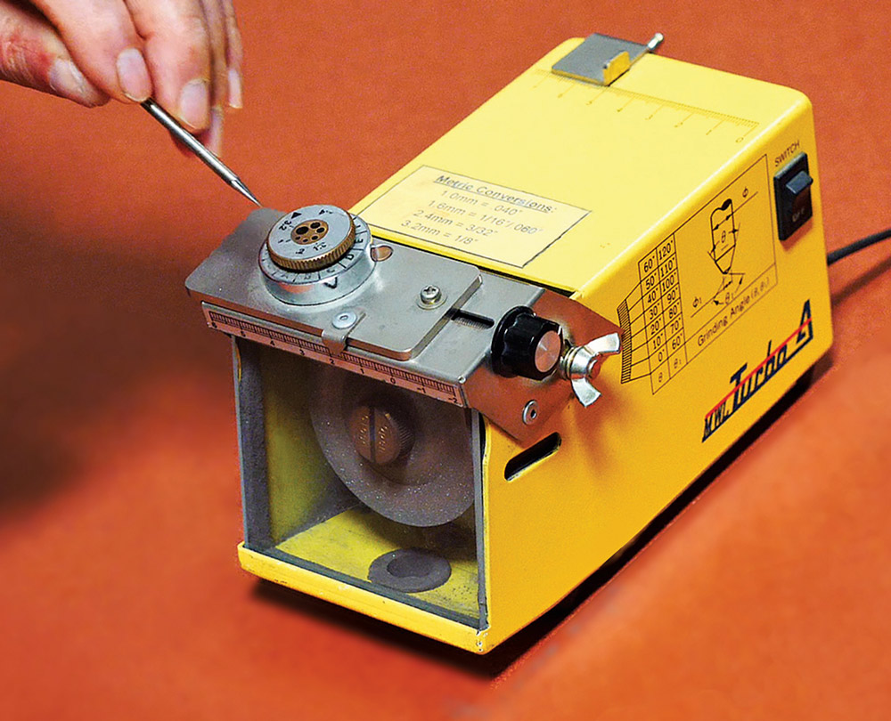 Turbo-A bench tungsten grinder, electrode insertion, angle charts and metric conversion visible