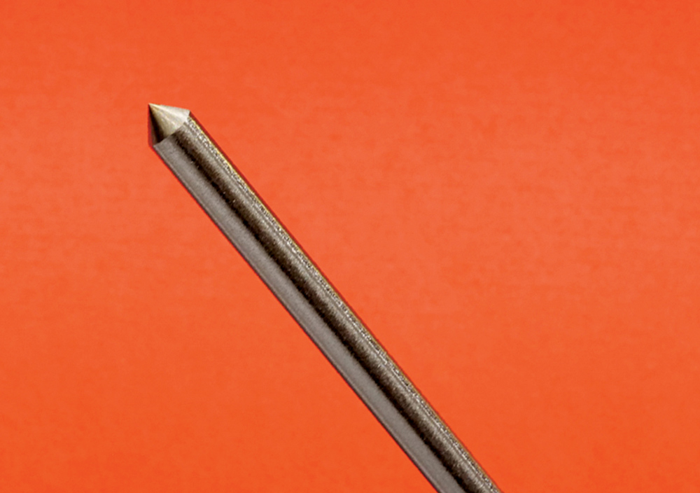 TIG tungsten electrode, sharpened conical tip, diagonal orientation, orange background