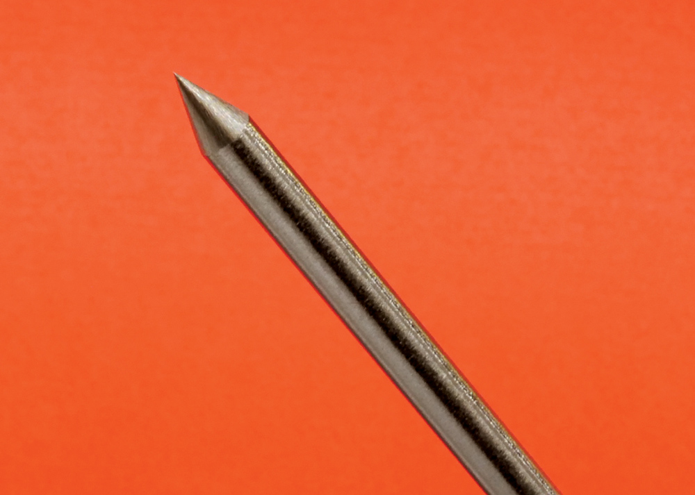 TIG tungsten electrode, precise taper, angled view, orange background