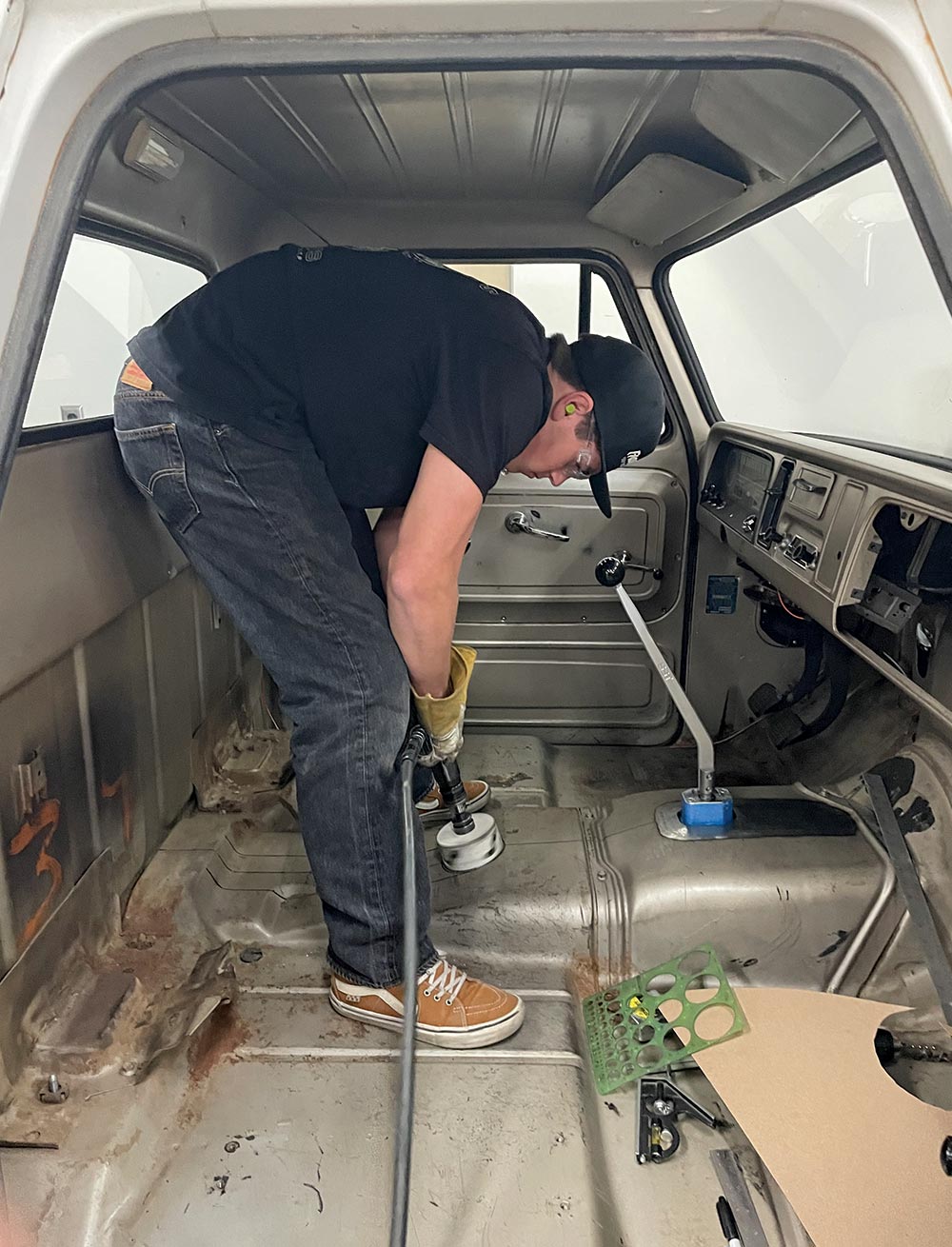 grinding transmission tunnel, prepping truck cab interior, 1960s Chevy C10