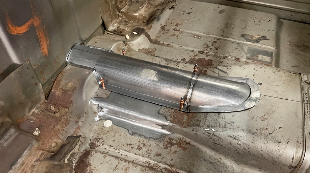 Custom transmission tunnel cover installed, cleco fasteners, ribbed dome, 1960s Chevy C10