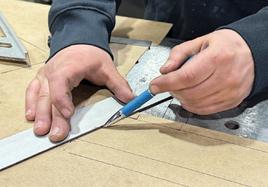 Marking cardboard template, blue pencil, metal ruler, perforated steel bench