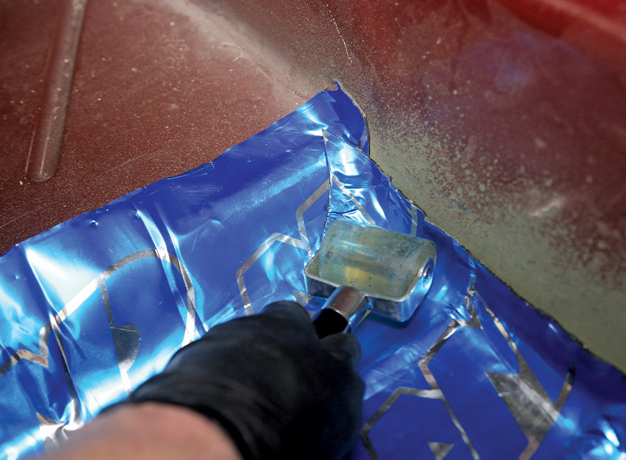 1995 Chevrolet Suburban sound deadening roller applying Noico sheet to floor pan