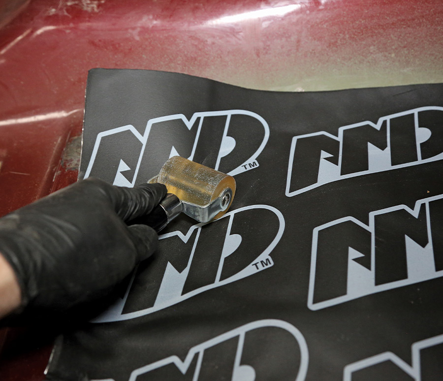 1995 Chevrolet Suburban rolling NDP insulation onto contoured floor sections