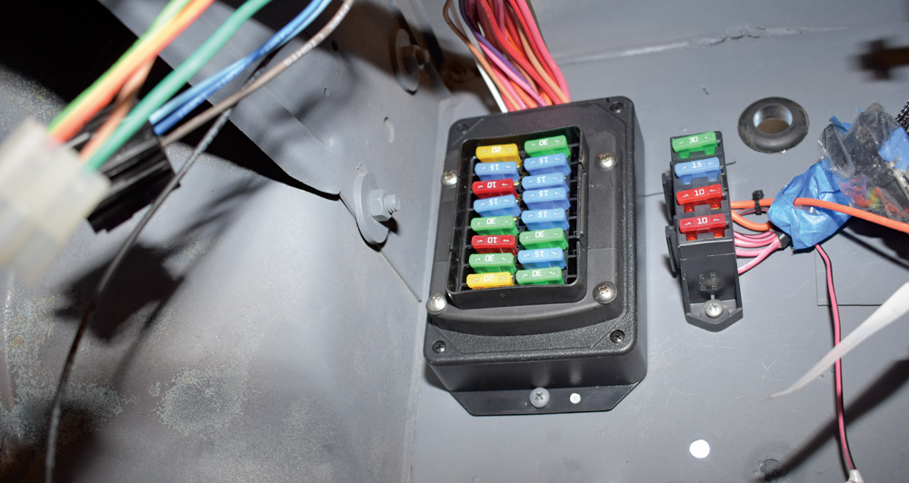 American Autowire fuse panel mounted inside cab with additional accessory block