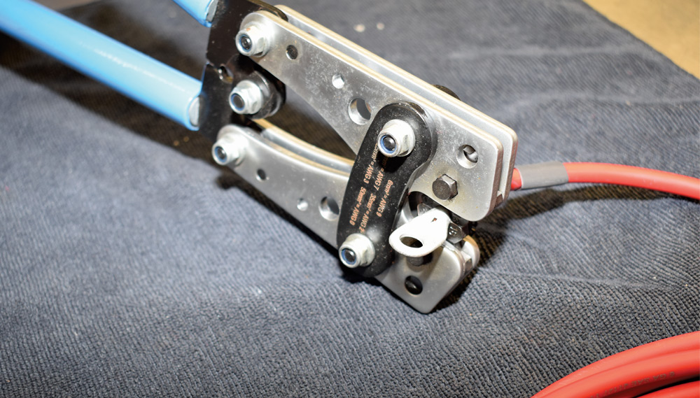 American Autowire heavy-gauge cable crimped using hydraulic lug crimper