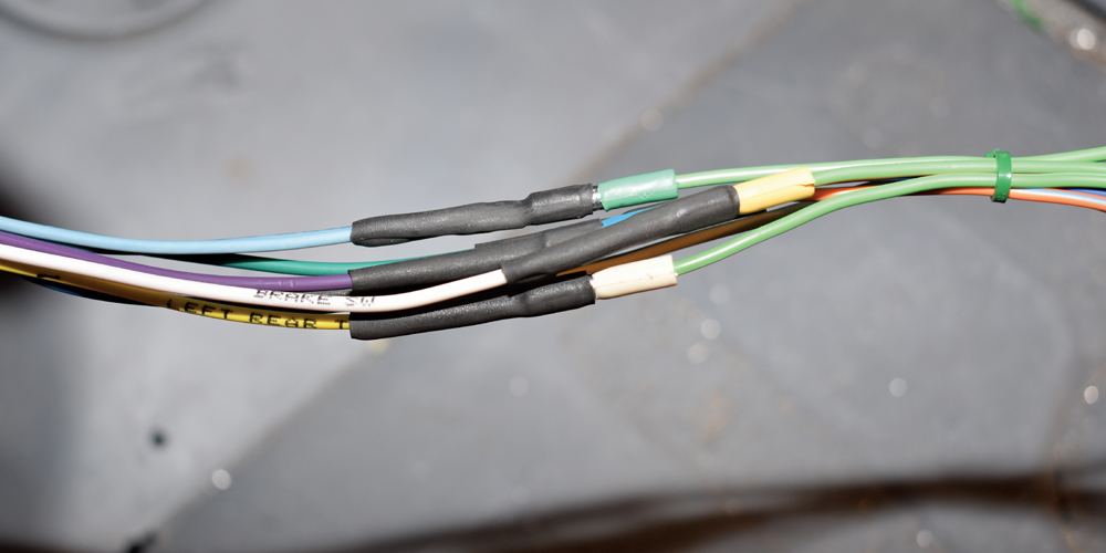 American Autowire heat-shrinked wiring splices secured after joining front harness circuits