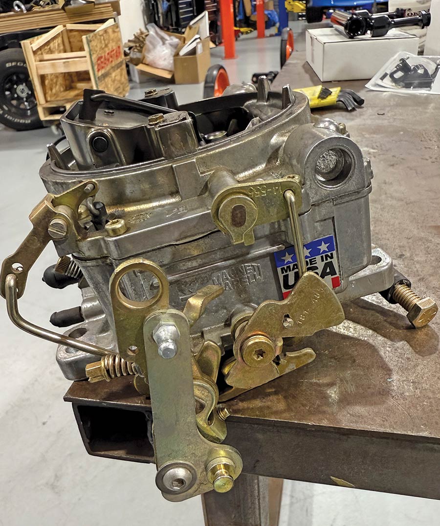 Edelbrock vrs415 initial fitment technician placing carb on intake small block chevy
